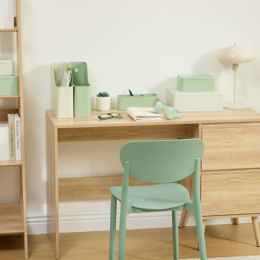 wooden desk with pastel green storage, matching chair, and organizing accessories for a functional workspace
